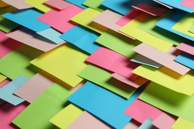 Photo of Colorful paper notes as background, closeup view