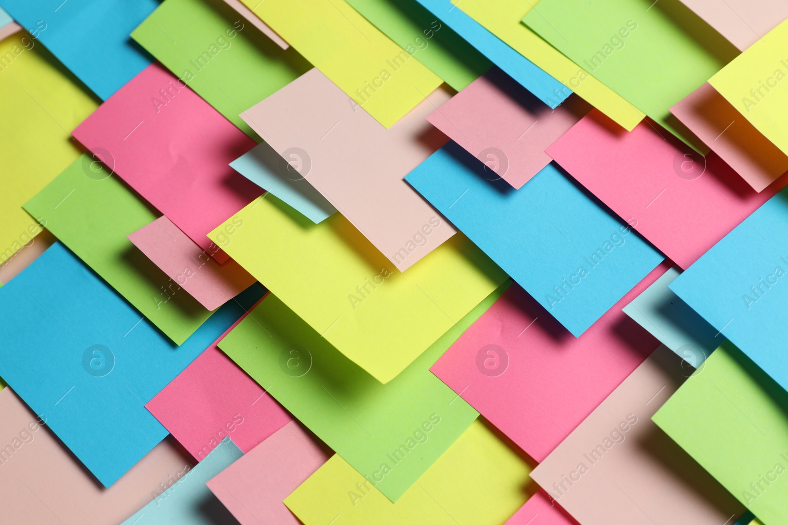 Photo of Colorful paper notes as background, closeup view