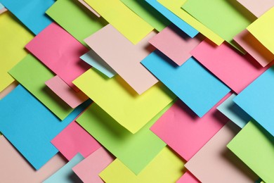 Photo of Colorful paper notes as background, closeup view