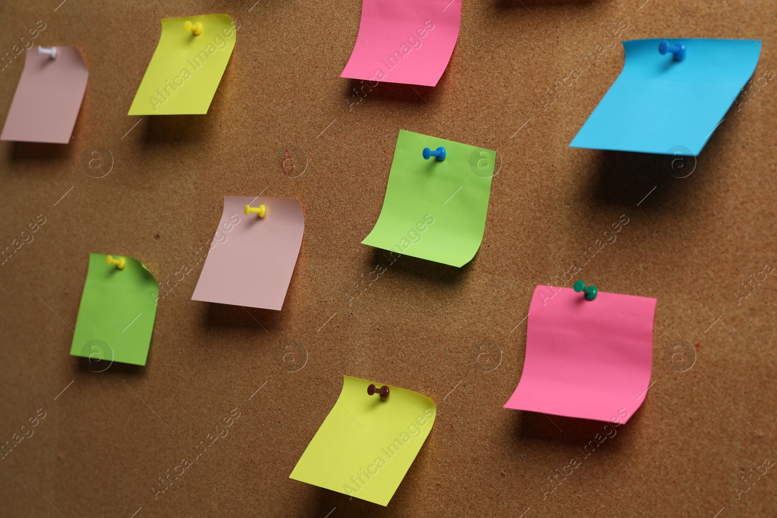 Photo of Colorful paper notes pinned to cork board