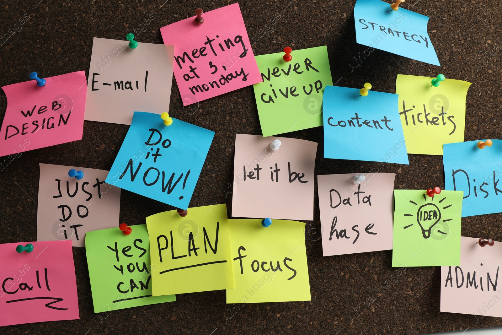 Photo of Colorful reminder notes pinned to cork board