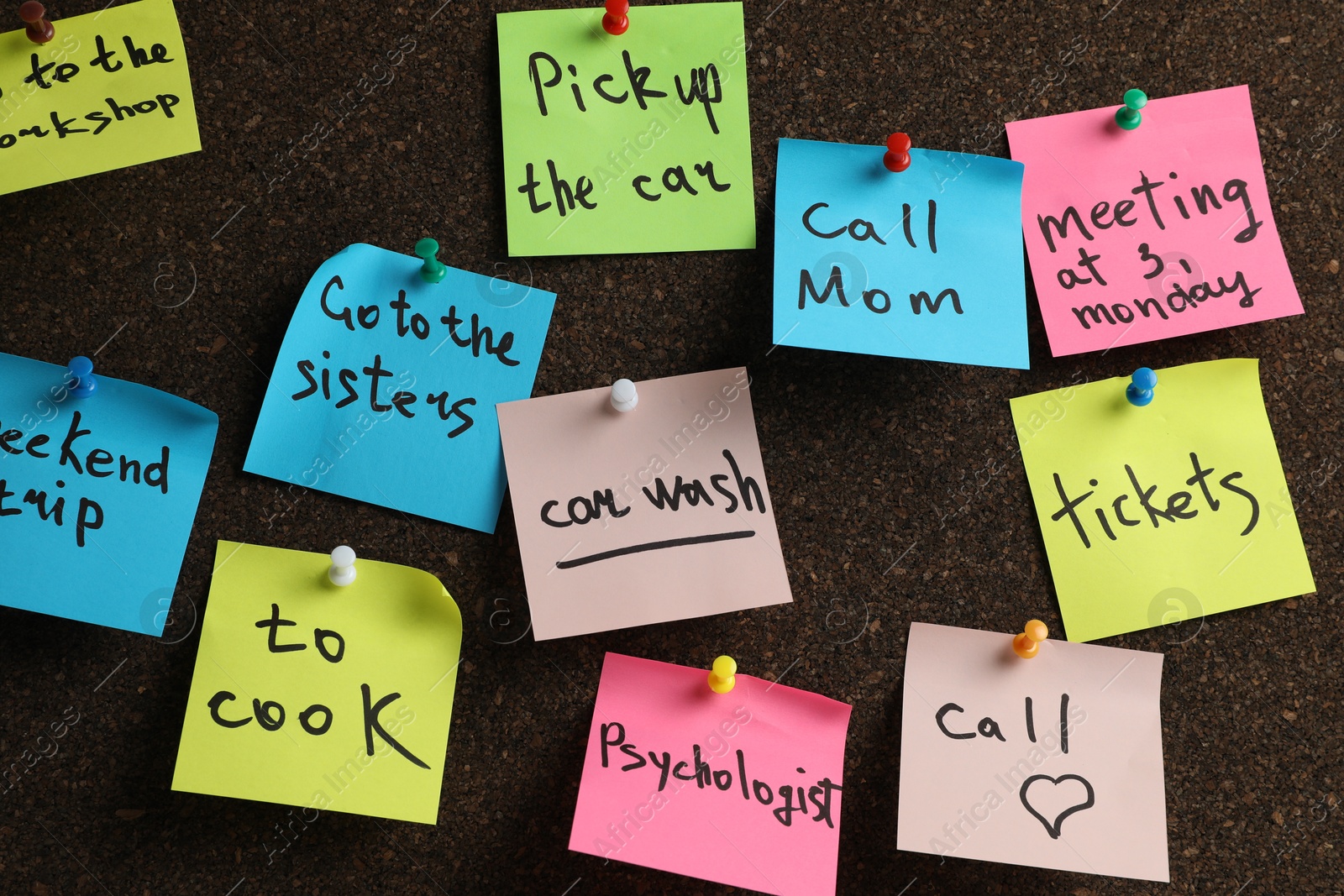 Photo of Colorful reminder notes pinned to cork board