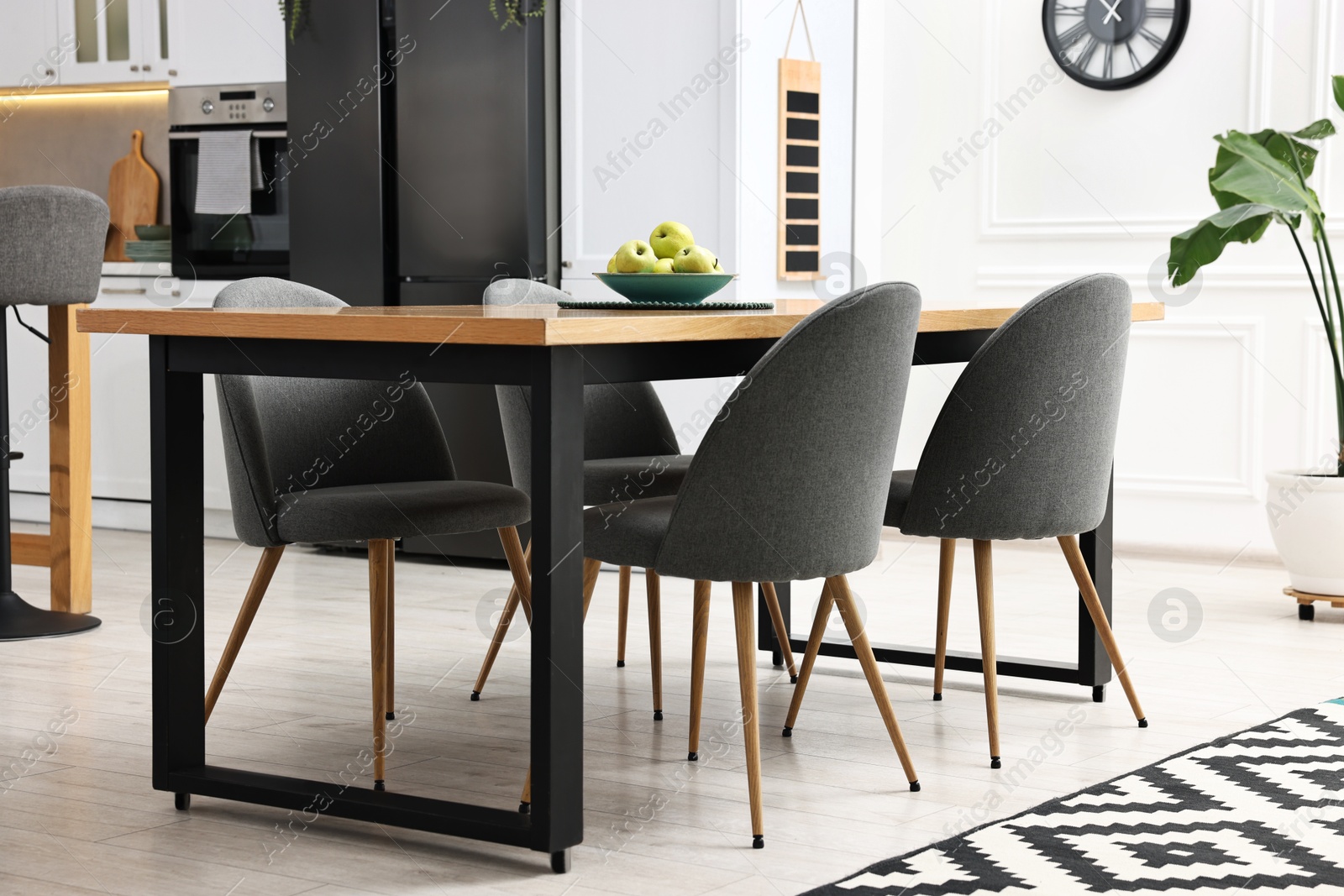 Photo of Grey chairs and table in stylish kitchen