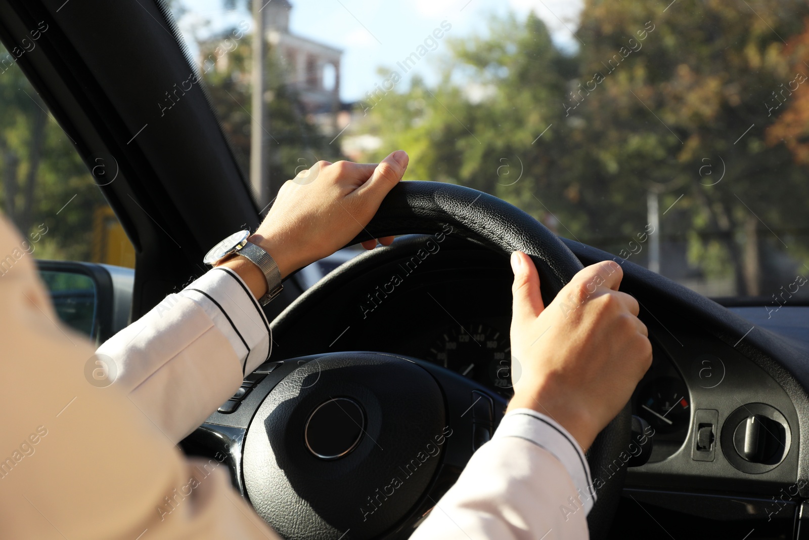 Photo of Woman holding steering wheel while driving car, closeup