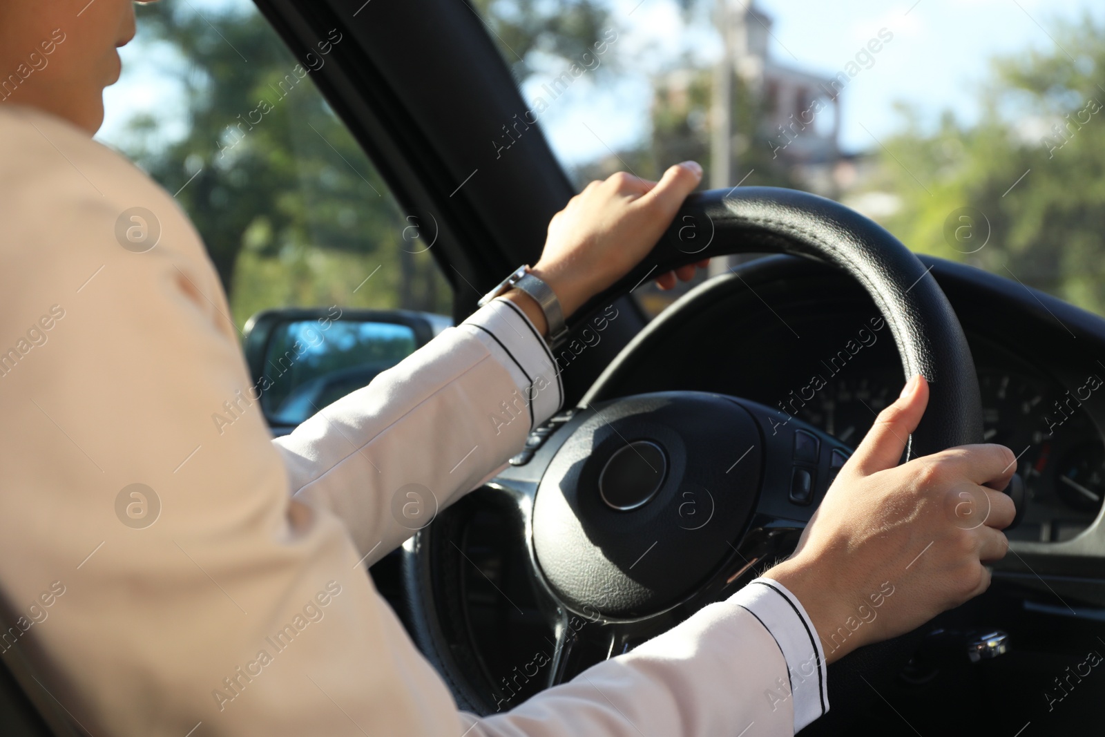 Photo of Woman holding steering wheel while driving car, closeup