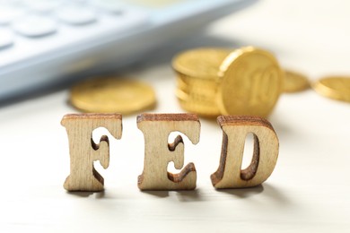 Photo of Wooden letters Fed (Federal Reserve System) on white table, closeup