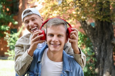 Family portrait of happy brothers outdoors on sunny day