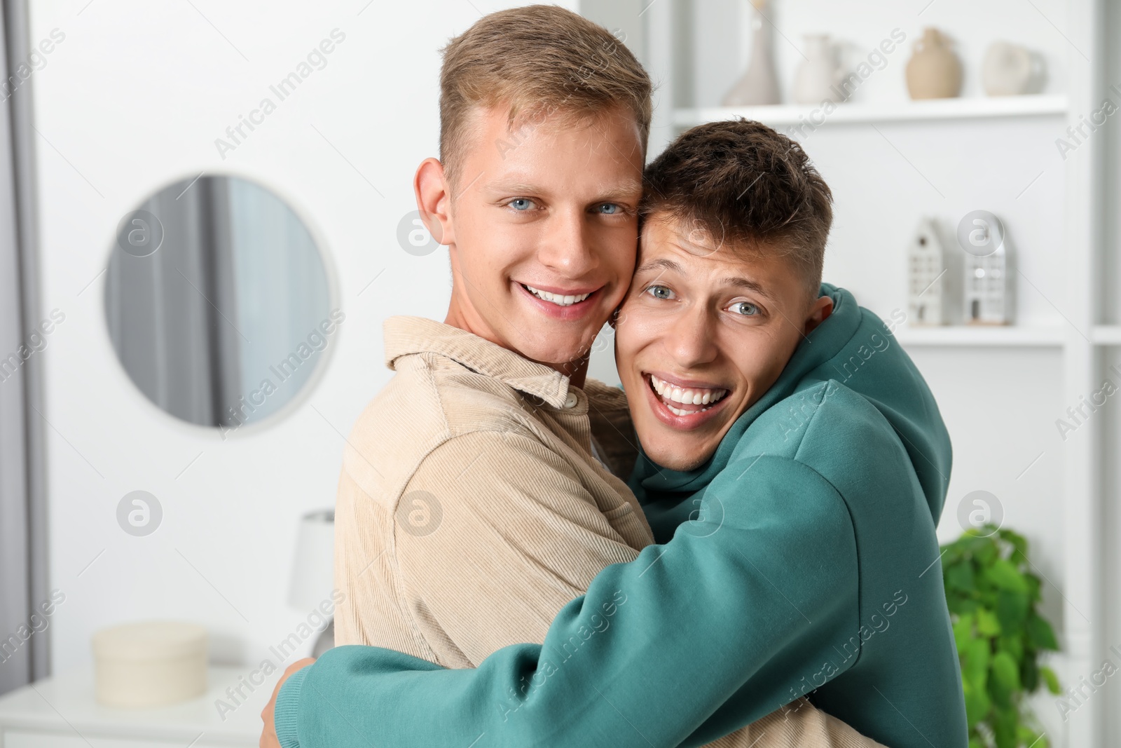 Photo of Family portrait of happy brothers hugging at home. Space for text