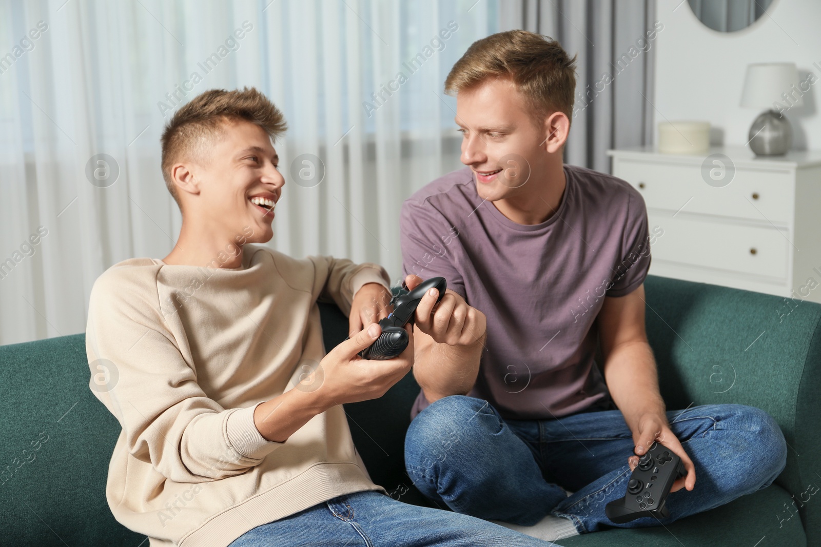 Photo of Happy brothers playing video game at home