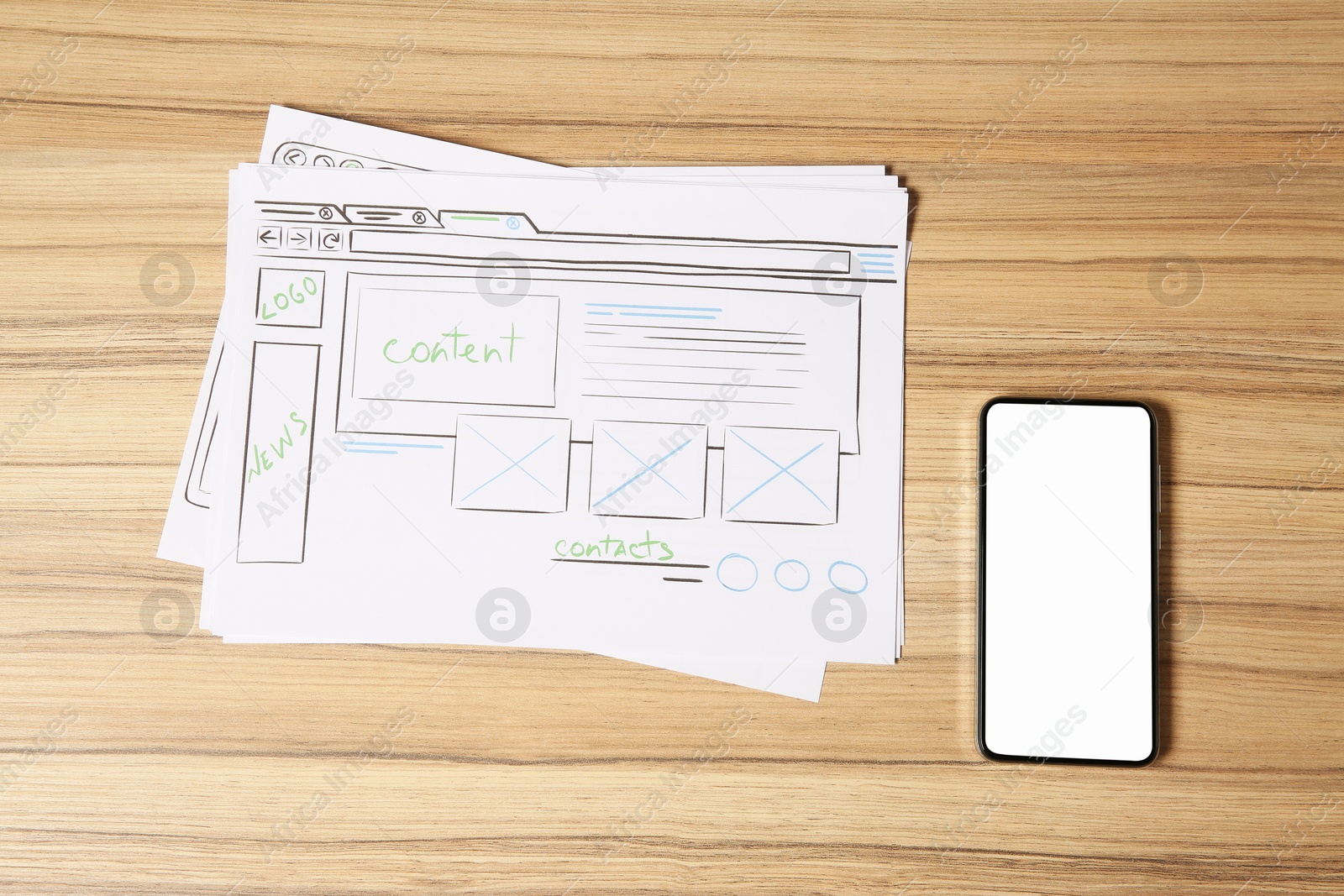 Photo of Website development. Sketches of wireframes and smartphone on wooden table, flat lay