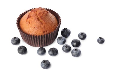 Photo of Delicious sweet muffin and blueberries isolated on white