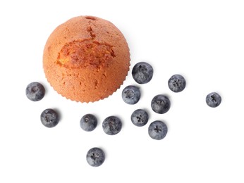 Photo of Delicious sweet muffin and blueberries isolated on white, top view