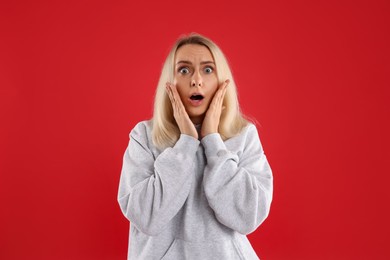 Photo of Portrait of scared woman on red background