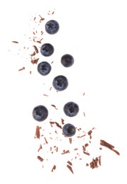 Photo of Fresh blueberries and crushed chocolate pieces isolated on white