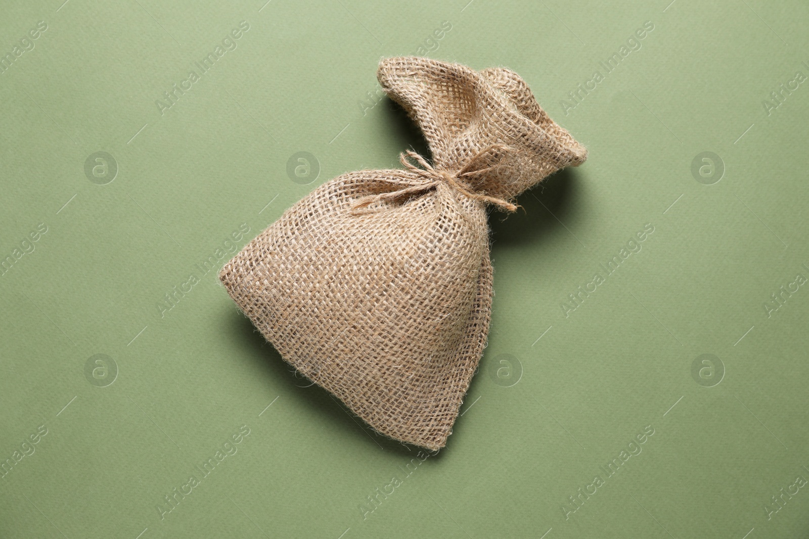 Photo of One burlap sack on olive background, top view