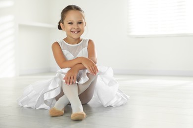 Photo of Portrait of little ballerina indoors, space for text