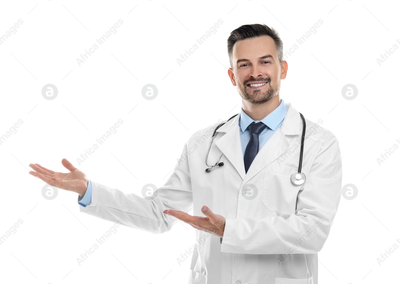 Photo of Smiling doctor with stethoscope pointing at something on white background