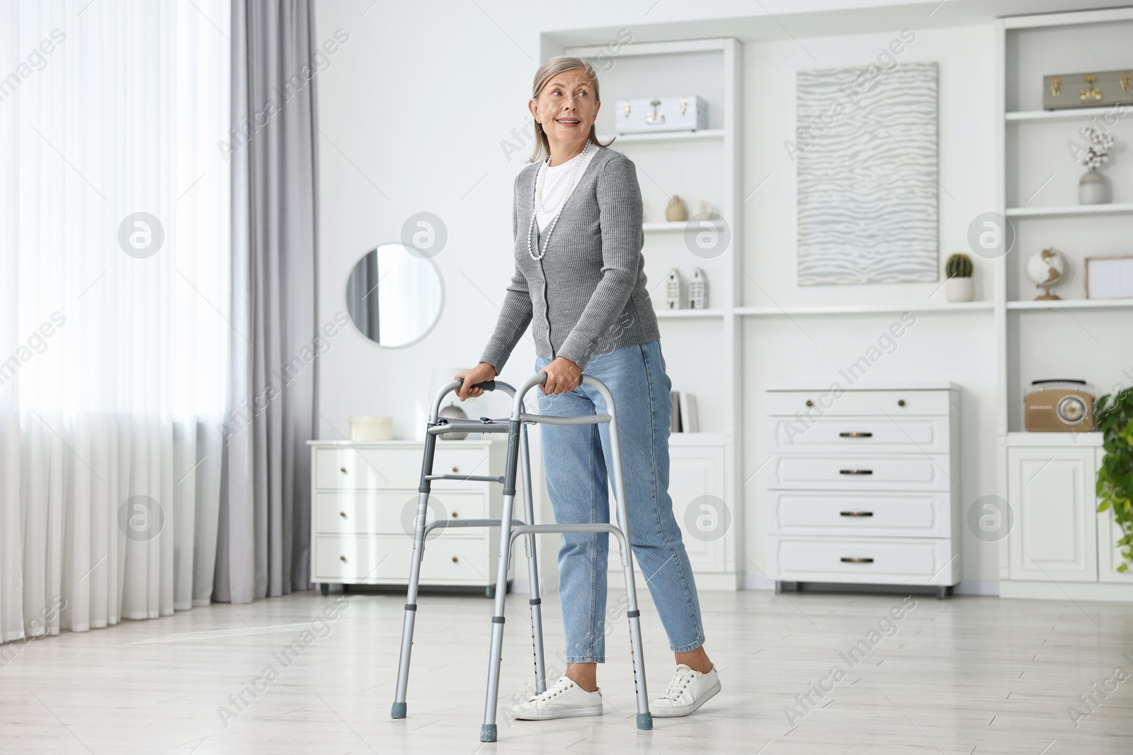 Photo of Senior woman with walking frame at home