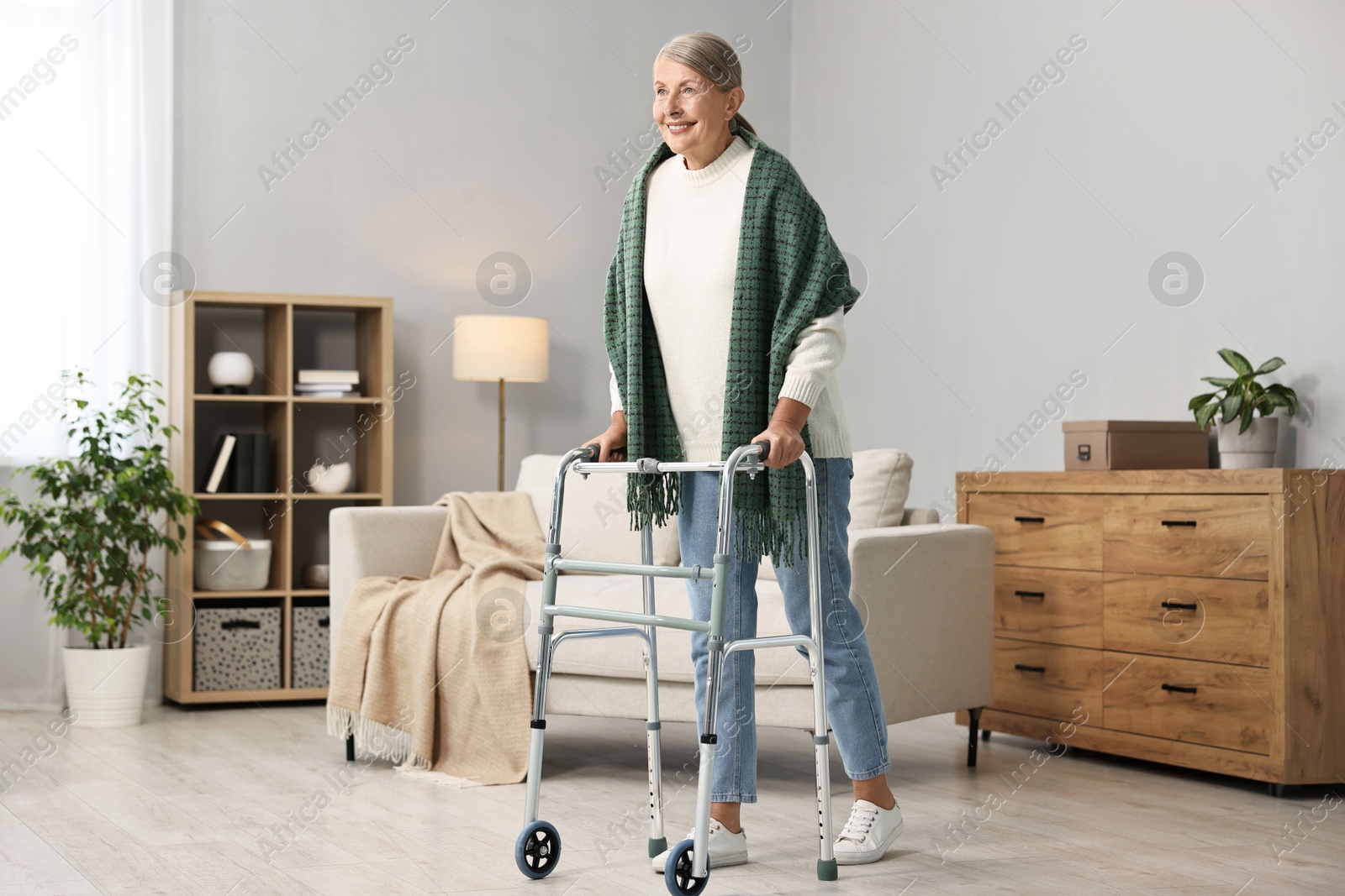 Photo of Senior woman with walking frame at home