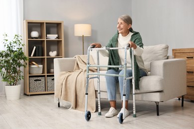 Senior woman with walking frame on sofa at home