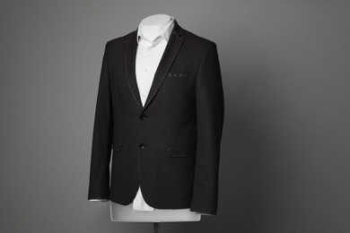 Photo of Semi-ready jacket and white shirt on male mannequin against grey background