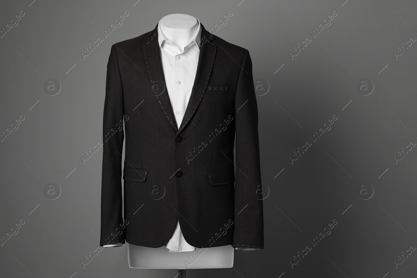 Photo of Semi-ready jacket and white shirt on male mannequin against grey background