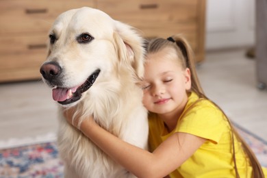 Photo of Girl with her cute Golden Retriever dog at home