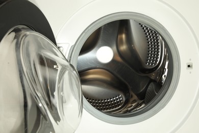 Photo of Washing machine with empty drum as background, closeup