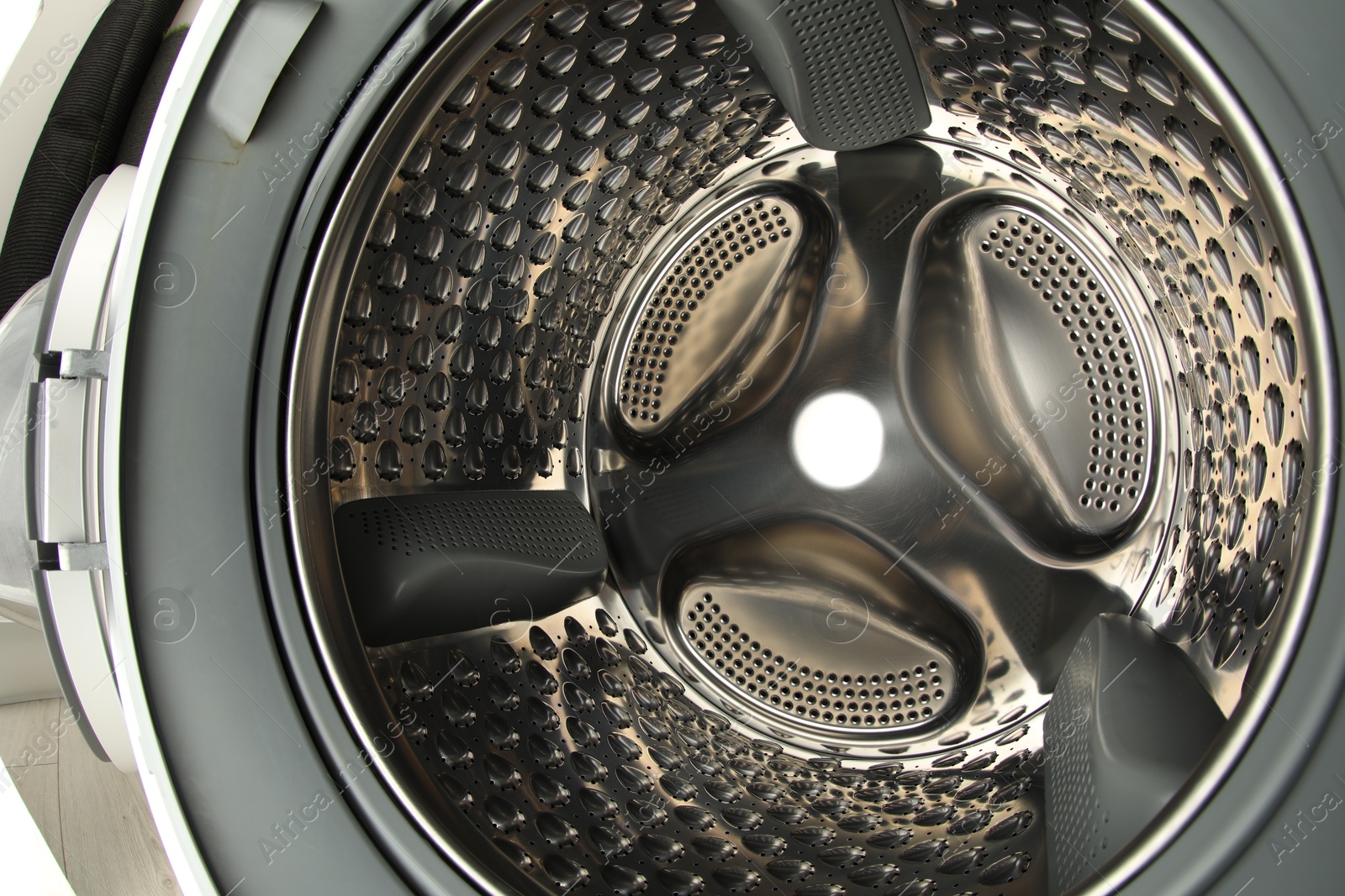 Photo of Washing machine with empty drum as background, closeup