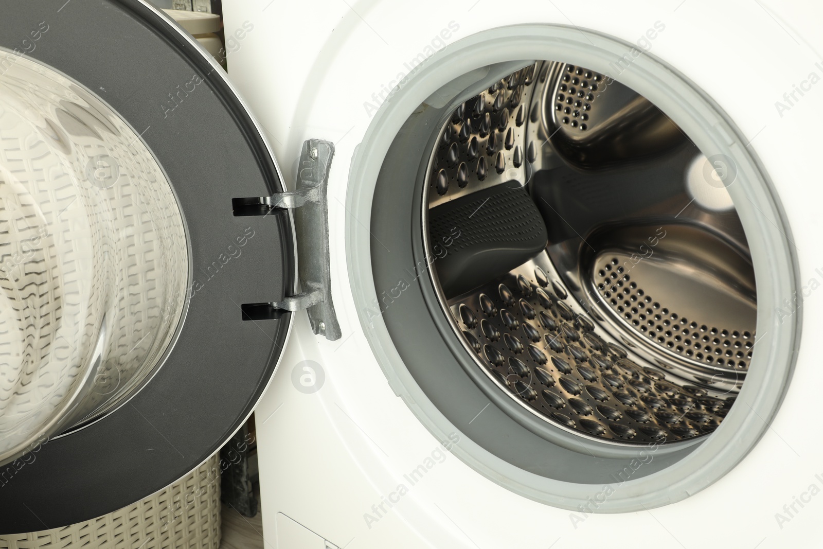 Photo of Washing machine with empty drum as background, closeup