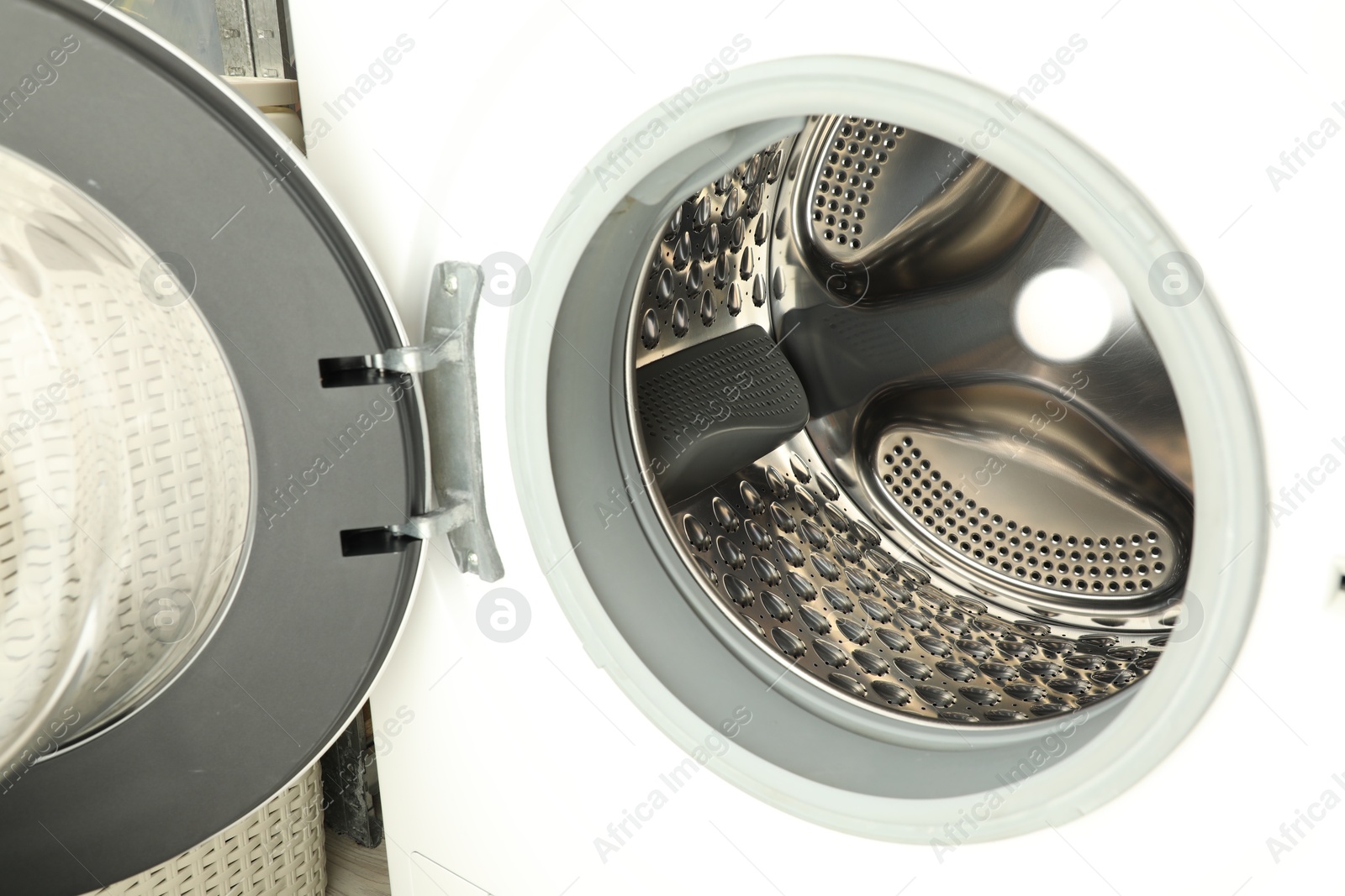 Photo of Washing machine with empty drum as background, closeup