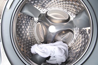 Washing machine with towel as background, closeup