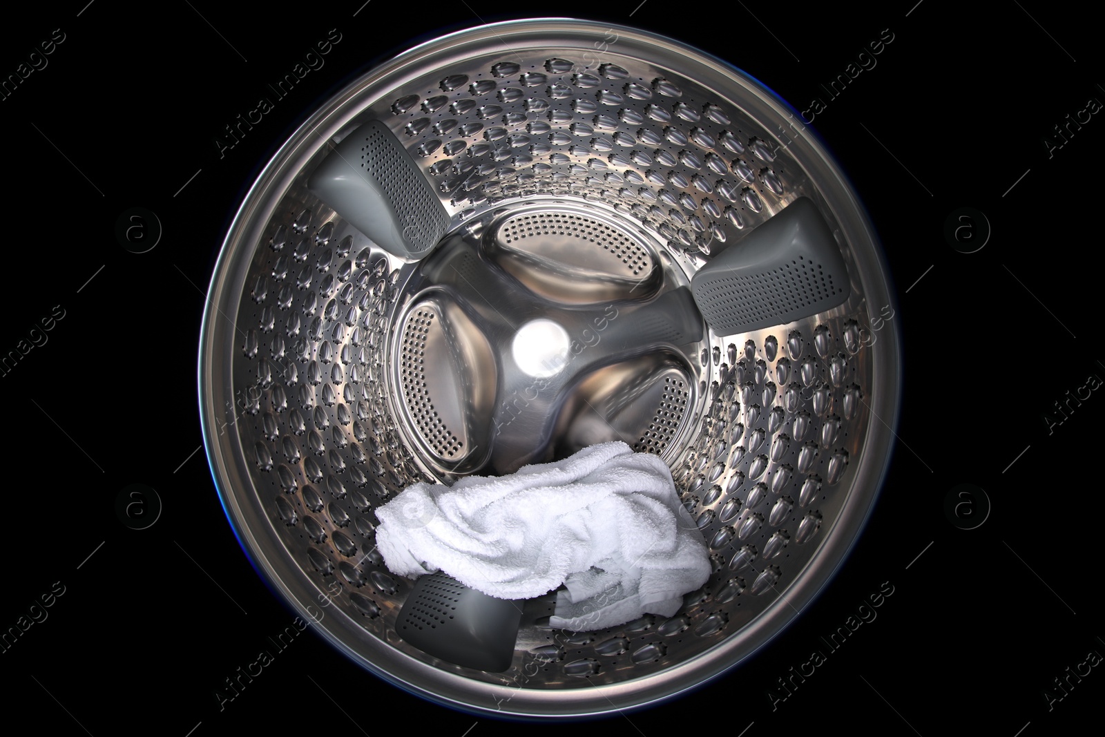 Photo of Washing machine with towel as background, closeup