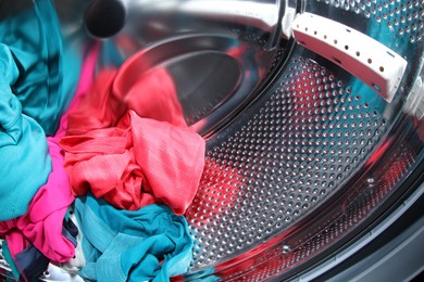 Photo of Washing machine with laundry as background, closeup