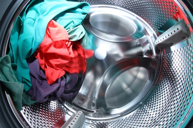 Washing machine with laundry as background, closeup