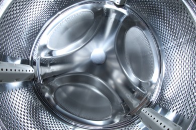 Photo of Washing machine with empty drum as background, closeup