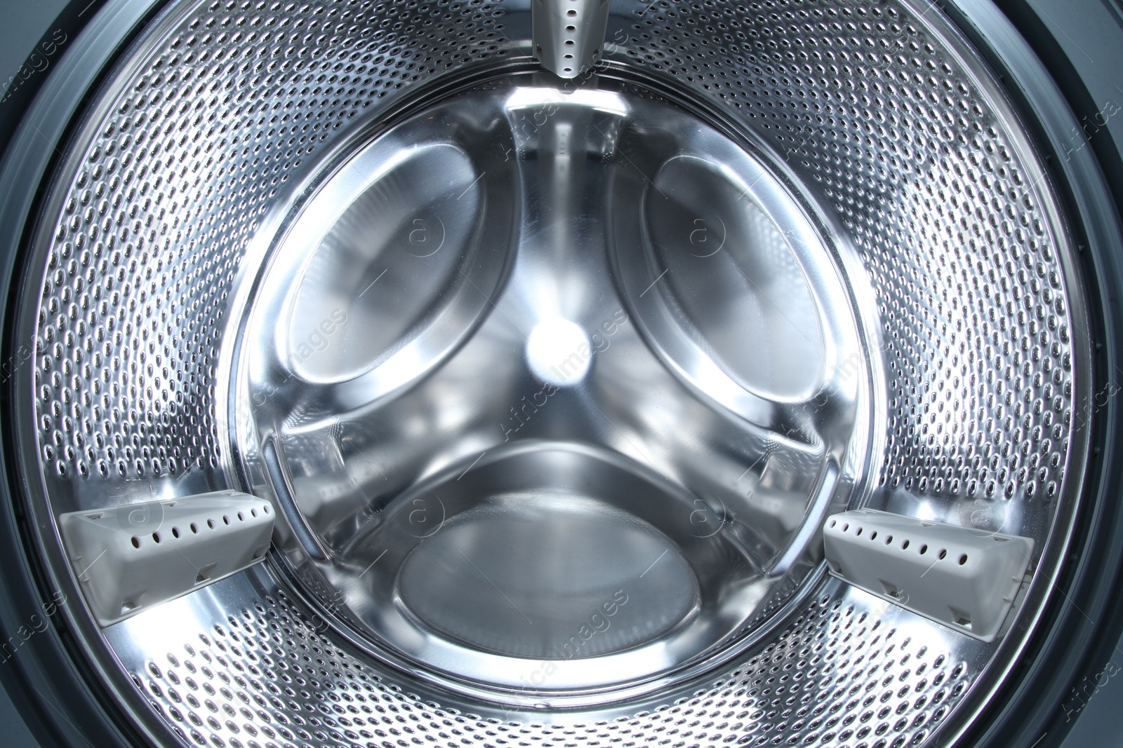 Photo of Washing machine with empty drum as background, closeup