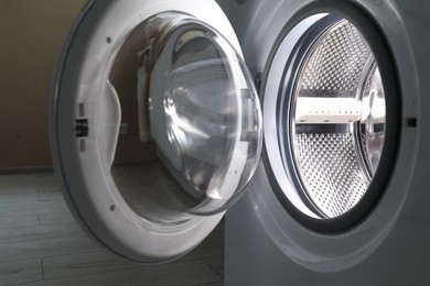 Photo of Washing machine with empty drum indoors, closeup