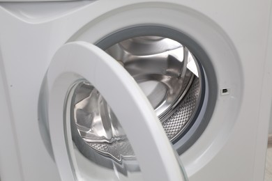 Washing machine with empty drum as background, closeup