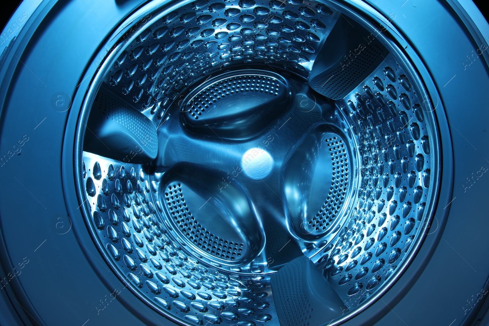 Photo of Washing machine with empty drum as background, closeup