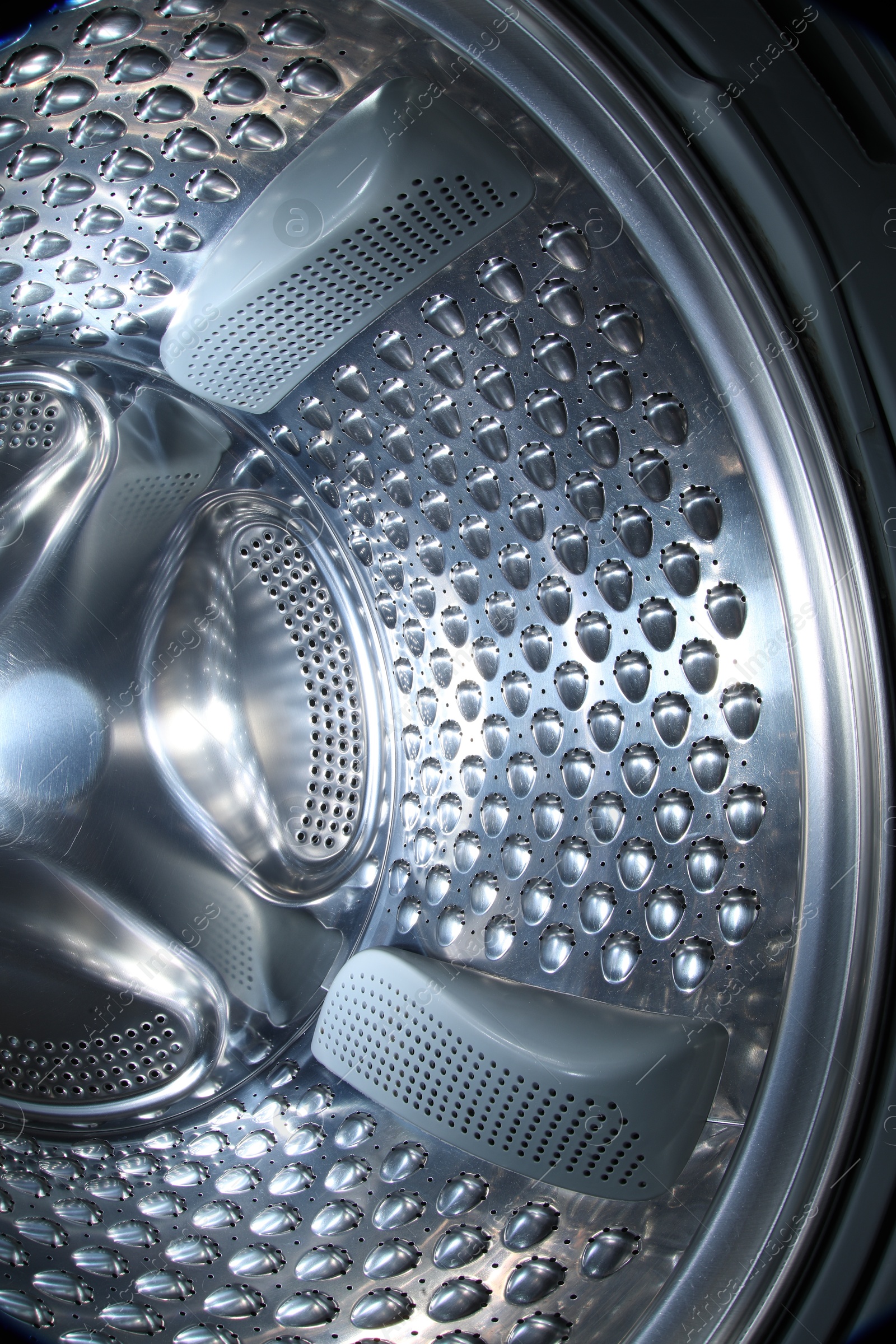 Photo of Washing machine with empty drum as background, closeup