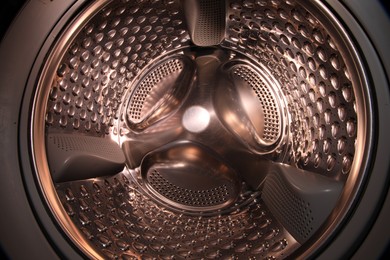 Photo of Washing machine with empty drum as background, closeup