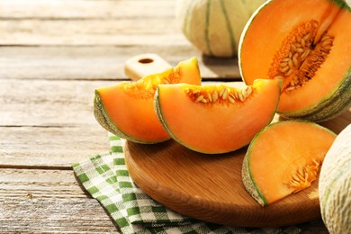 Tasty ripe Cantaloupe melons on wooden table, closeup