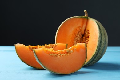 Photo of Cut ripe Cantaloupe melon on light blue wooden table, closeup