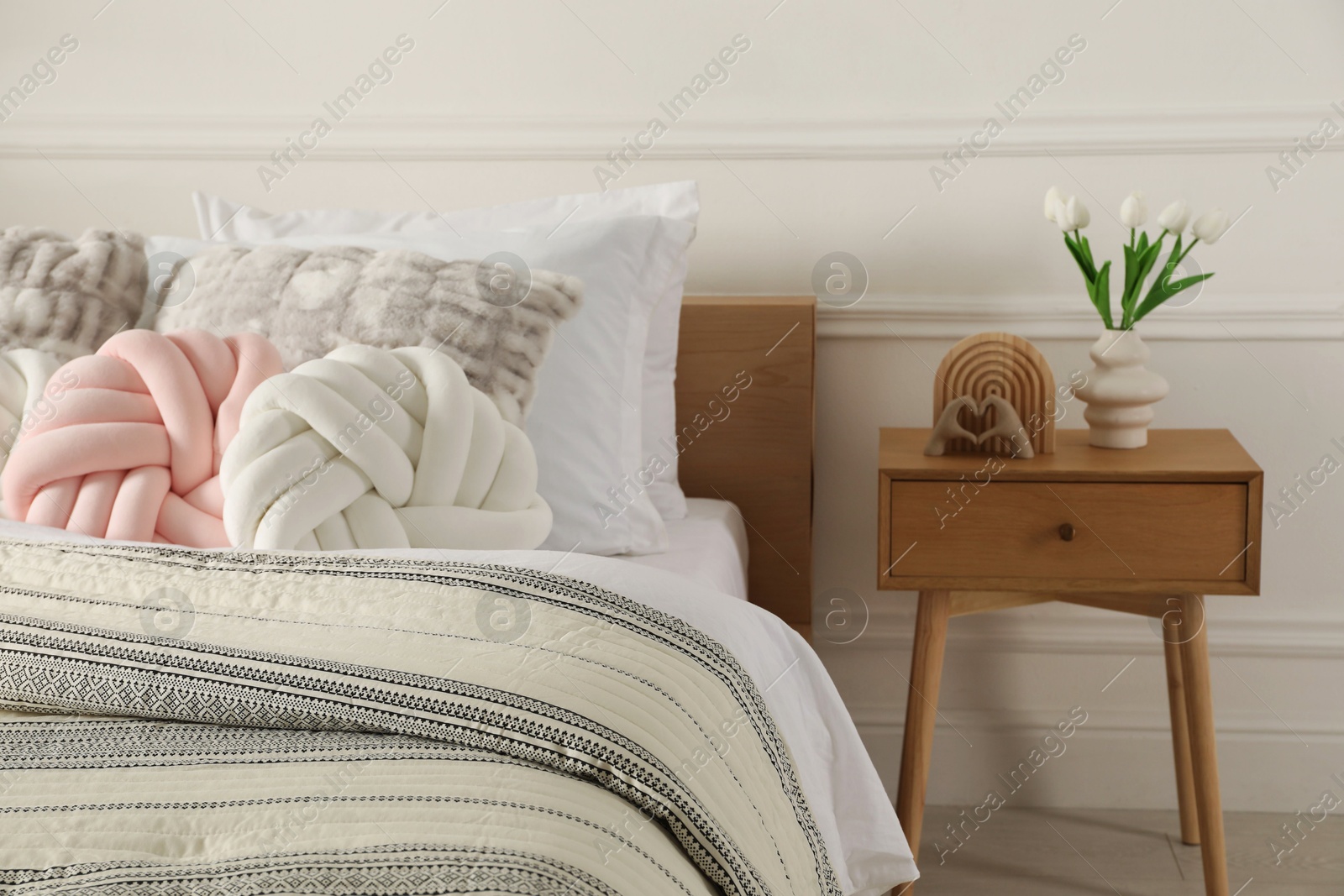 Photo of Bed with beautiful cushions in room. Interior design