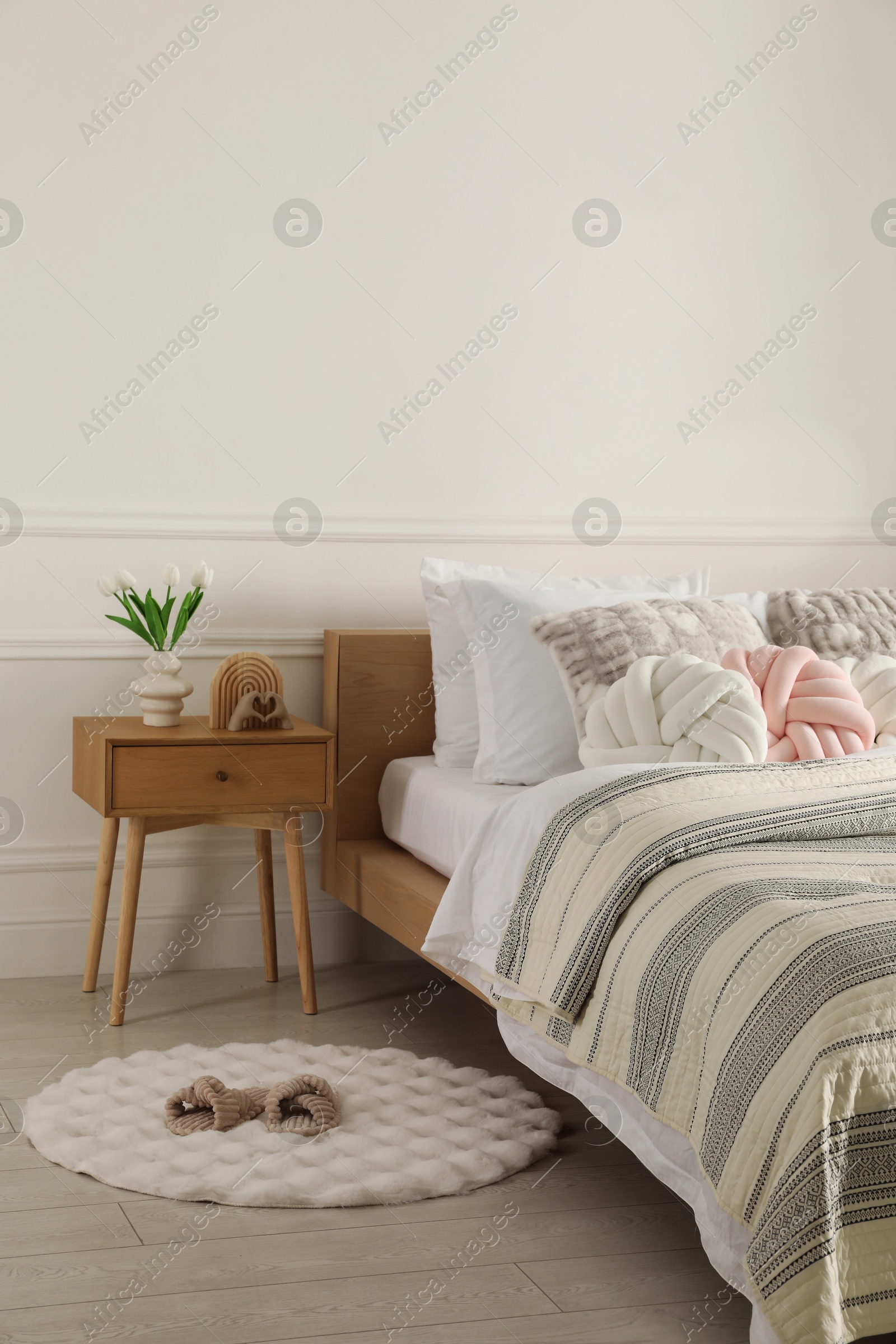 Photo of Bed with beautiful cushions in room. Interior design