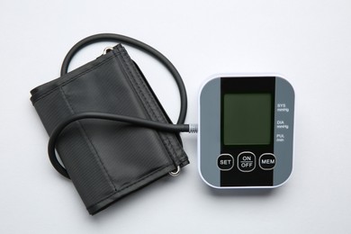 Photo of Blood pressure measuring device on white background, top view