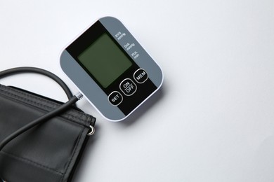 Photo of Blood pressure measuring device on white background, top view. Space for text