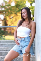 Beautiful woman wearing stylish denim shorts outdoors