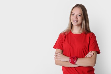 Portrait of teenage girl on white background, space for text